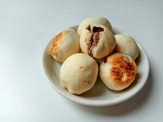 Nopia, is a traditional snack from Banyumas, Indonesia. Made from flour dough filled with red sugar, baked in a furnace. Isolated on white background.