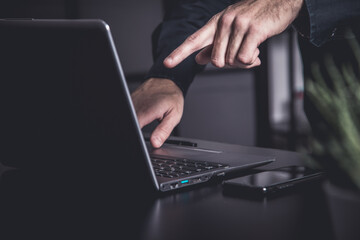 Businessman using a smartphone and notebook in a moddy office