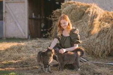 A girl and two cats near a haystack 3269.
