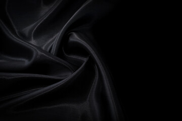 Part of the dark fabric texture of the fabric for the background and decoration of the work of art, a beautiful crumpled pattern of silk or linen. A crumpled piece of cloth