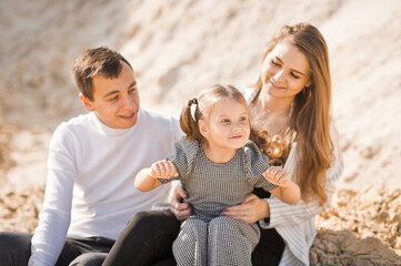 A young family is sitting among the sandy mountains 3358.