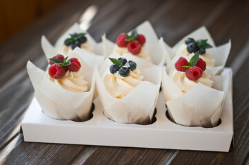 Six cream cakes decorated with berries on a stand 3623.