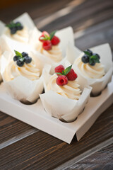 Six cream cakes decorated with berries on a stand 3624.