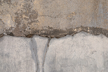 Cracked old stone wall, with grey surface and rough structure, space for text, no person