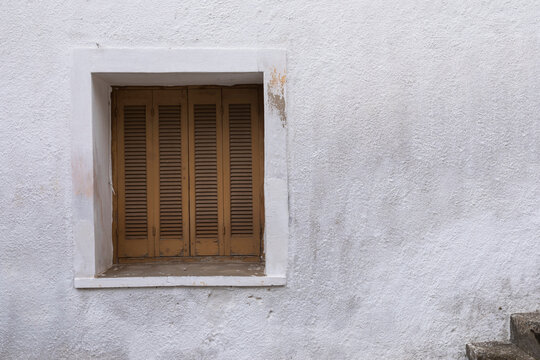 White Painted Wall With Closed Window, Frame With Brown Shutter, 
Space For Text, Lock Down