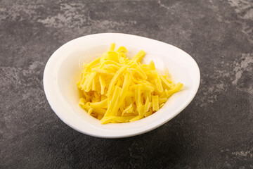 Shredded yellow cheese in the bowl
