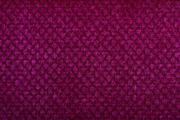 Purple fabric texture. Furniture upholstery textiles. Embossed pattern. Woven fibers. The material is soft touch. Minimalism concept. High detail macro photography for backgrounds or wallpapers.