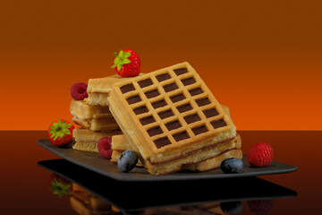 Waffles With Fruit and Maple Syrup on Colored Background