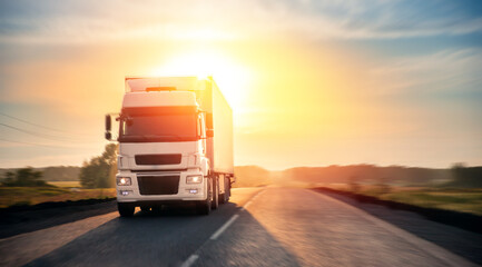 Truck with container on highway with sun light. Concept cargo transportation banner. Blur move...