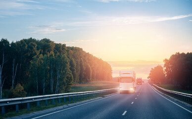 Truck with container on highway with sun light, concept cargo transportation. Blur move effect.