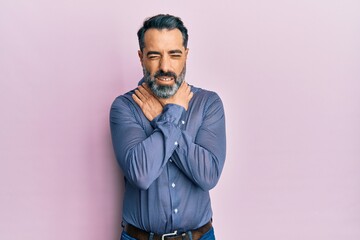 Middle age man with beard and grey hair wearing business clothes shouting and suffocate because painful strangle. health problem. asphyxiate and suicide concept.