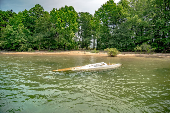 dirty sunken boat floating in the lake