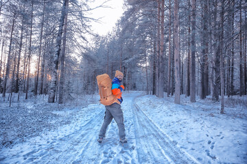man traveler with a backpack in the forest, winter view in the american forest, north america...