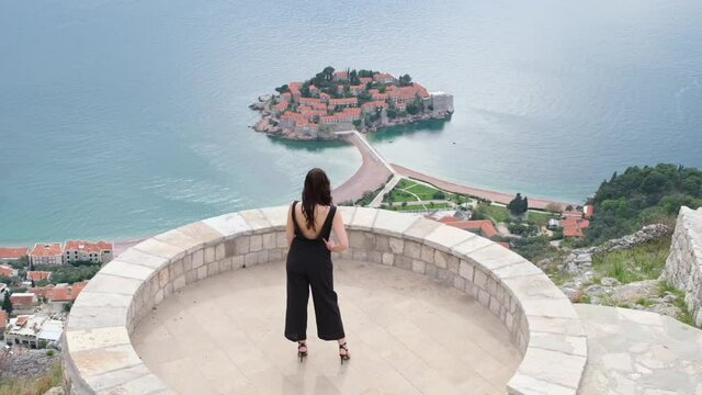 beautiful woman looking at view on city terrace. tourist woman watching the city