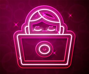 Glowing neon line Student working at laptop icon isolated on red background. Workplace concept. Vector