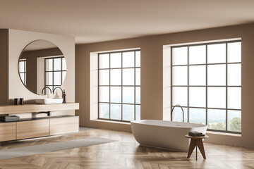 Light bathroom interior with sink and mirror, bathtub with towels near window