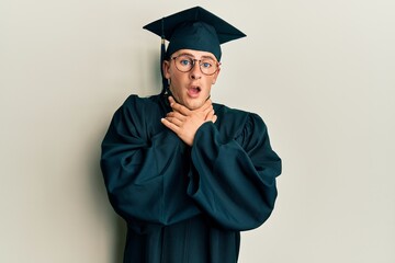 Young caucasian man wearing graduation cap and ceremony robe shouting and suffocate because painful strangle. health problem. asphyxiate and suicide concept.