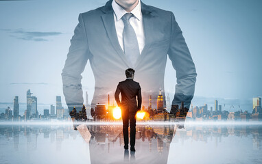 Businessman with hands in pocket and office skyscrapers, panoramic view