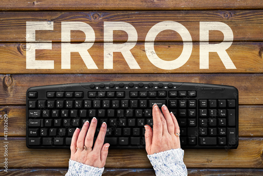 Poster error. pc keyboard and error word on wooden desk