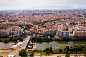 Fototapeta na wymiar Bird's eye view of Perpignan, France. Residential buildings and Tet River visible from above.