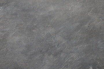 Empty dark gray concrete background with scratches and bumps. Concrete texture close-up