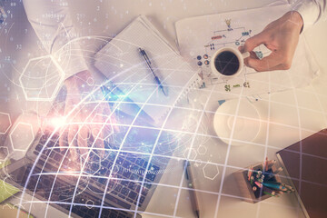 Multi exposure of man's hands typing over computer keyboard and world map hologram drawing. Top view. Technology concept.