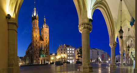 Night photography of the Main Square in Krakow. View from the Cloth hall on the St. Mary's Basilica. Krakow, Poland.