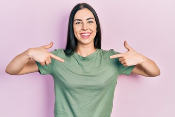 Beautiful woman with blue eyes wearing casual t shirt looking confident with smile on face,...