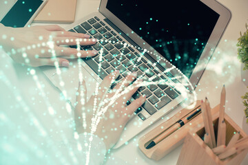 Double exposure of woman hands typing on computer and DNA hologram drawing. Medical education...