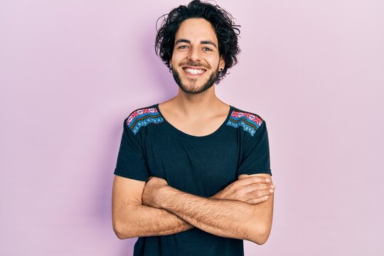 Handsome hispanic man with arms crossed gesture smiling with a happy and cool smile on face. showing teeth.