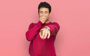 Young handsome man wearing casual clothes laughing at you, pointing finger to the camera with hand...