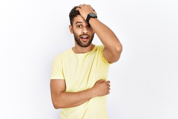 Fototapeta premium Arab young man standing over isolated background surprised with hand on head for mistake, remember error. forgot, bad memory concept.