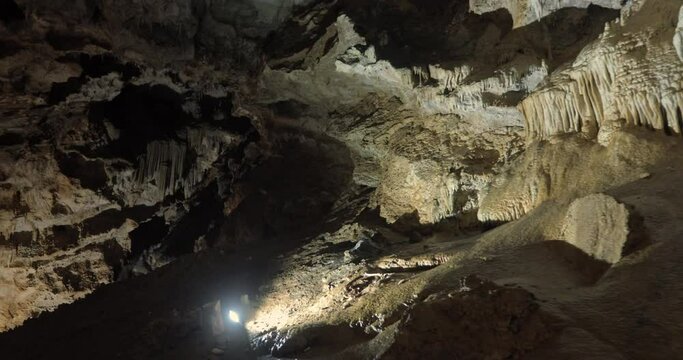 Beautiful shots of karst cave, Lipa Cave situated Serbia, East Europe. Illuminated dark cave with stalactites and stalagmites. Unique nature landscape. High quality 4k footage
