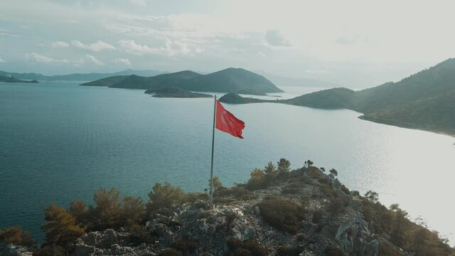 turkish flag at the top of the mountain. turkish flag at the top at sunset