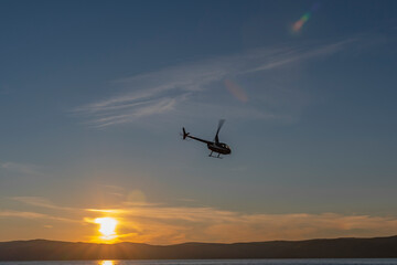 helicopter at sunset