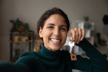 Selfie of happy homeowner. Excited latin female take self portrait on phone proud of buying house...