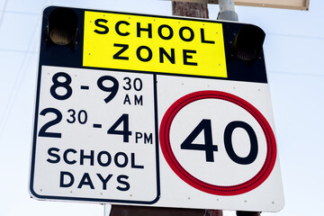 School zone road sign with speed limit 40 during before and after school hours in NSW, Australia. Road safety