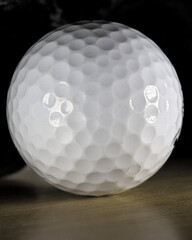 Golf ball on a wooden surface