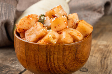 Traditional Korean cuisine salad of fermented daikon radish. Close-up. Korean Panchan appetizer