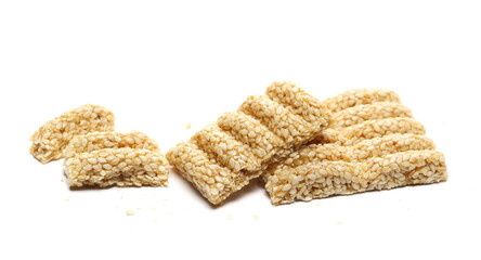 Sesame bar pieces isolated on white background