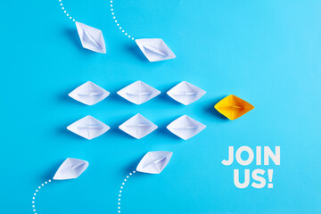 Paper boat leads white paper ships with new ones joining the team. Join us, job vacancy or...