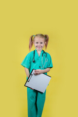 Portrait of little kid dressed in doctors green coat with a tablet in hand
