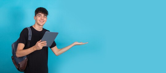 isolated teenage student with tablet and backpack in background