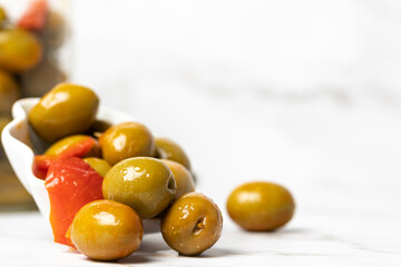 macro photograph of green olives on white background.. selective focus. copy space