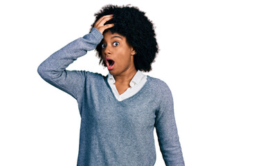 Young african american woman wearing business clothes surprised with hand on head for mistake,...