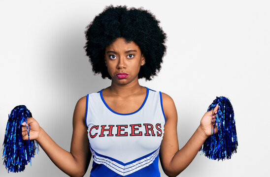 Young african american woman wearing cheerleader uniform using pompom depressed and worry for distress, crying angry and afraid. sad expression.