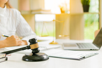 Lawyer Counseling Law Male judge in the courtroom on wooden table with hammer and scales and working in office Legal concepts, advice and justice