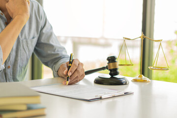 Lawyer Counseling Law Male judge in the courtroom on wooden table with hammer and scales and working in office Legal concepts, advice and justice