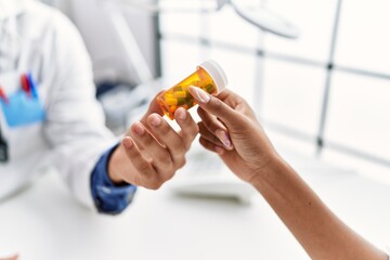 Man and woman wearing doctor uniform having medical consultation prescribe pills at clinic