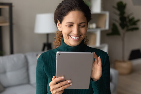 Gadgets In Modern Life. Happy Smiling Young Lady Modern Electronic Tablet User Enjoy Easy Shopping From Home Download New App Watch Video. Positive Latin Woman Choose Course For Online Learning On Pad